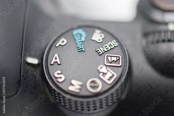 Fototapeta Camera settings dial showcasing various modes for photography in close up view