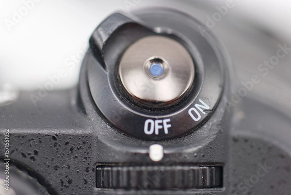 Fototapeta Camera power switch in close up showing off and on positions for photography equipment usage