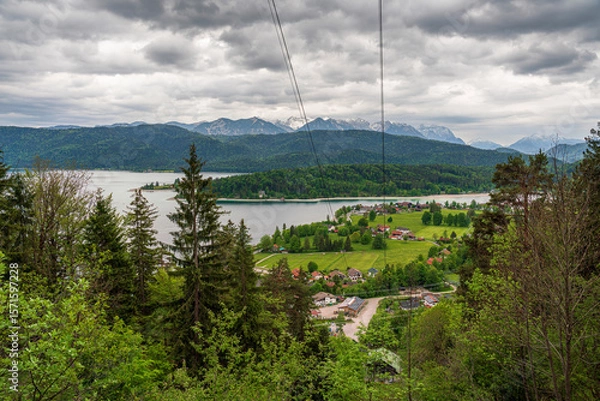 Obraz Herzogstand view to the Walchensee lake with a view though the forest trees