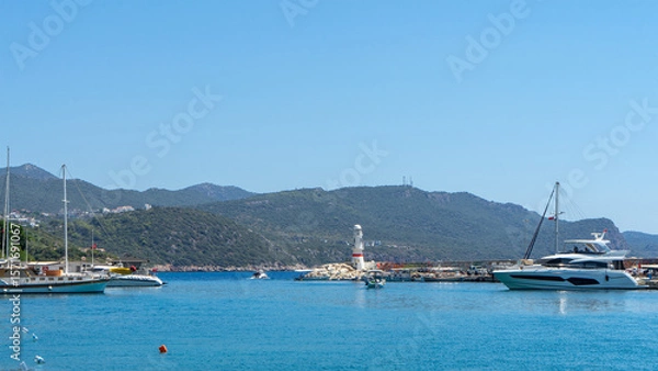 Fototapeta View of lighthouse in marina of Kas, Turkey. Active recreation and boat trips in Mediterranean Sea