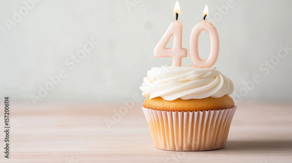 Fototapeta 40th birthday cupcake with number candles on a light background, with copy space for text.