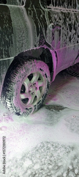 Fototapeta Car wash close-up with white and vibrant pink foam covering the vehicle. Self-service station. Cleaning process. Perfect for auto care, maintenance, and service concepts. Advertising.