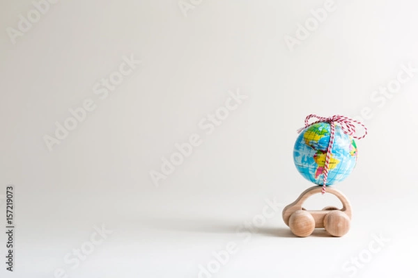 Obraz Toy car carrying a small globe