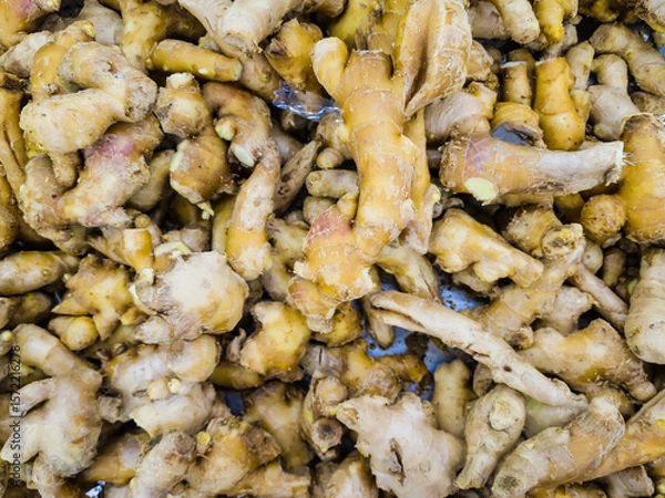 Fototapeta Ginger root. Fresh ginger root and ground ginger spice.
