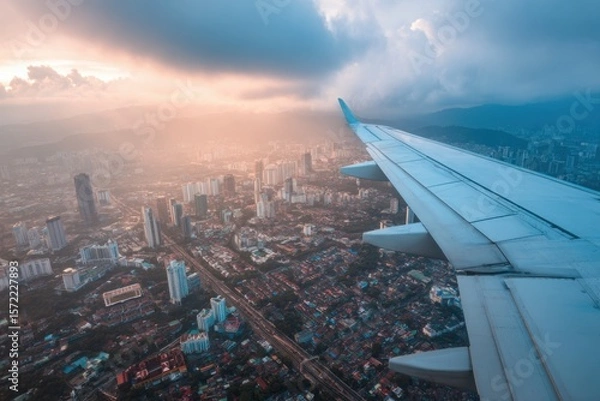 Obraz Aerial View of Cityscape at Sunset from Airplane Window Wing