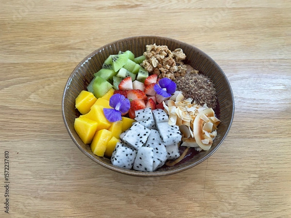 Fototapeta Acai bowl is a Brazilian-inspired dish made from pureed, frozen acai palm fruit, typically served in a bowl as a smoothie and topped with various ingredients. 
