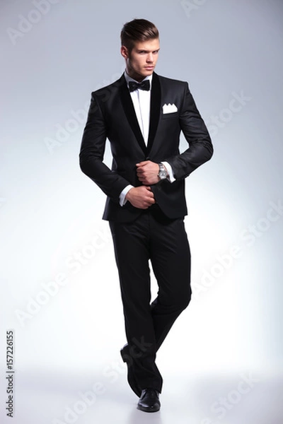 Fototapeta business man fixing his jacket