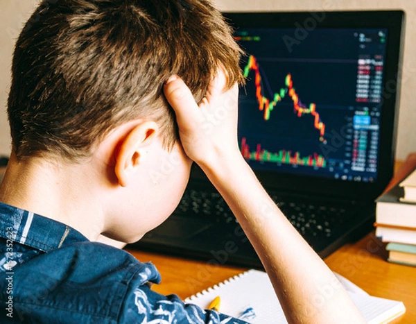 Obraz Frustrated Young Investor with Declining Stock Chart on Laptop, Boy Stressed by Investment Losses Watching Market Volatility