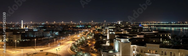 Fototapeta High angle view of illuminated buildings in Abu Dhabi at night