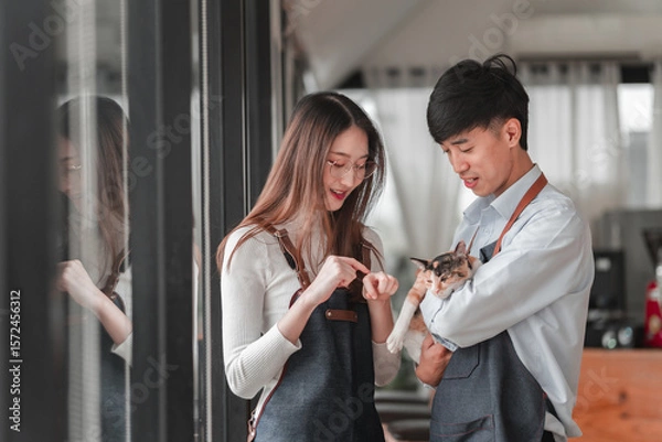 Obraz Young couple enjoying moment with pet in cozy indoor setting capturing joyful emotions