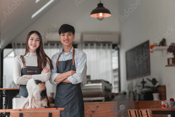 Obraz Smiling business partners with cat in cozy office, casual environment, friendly atmosphere