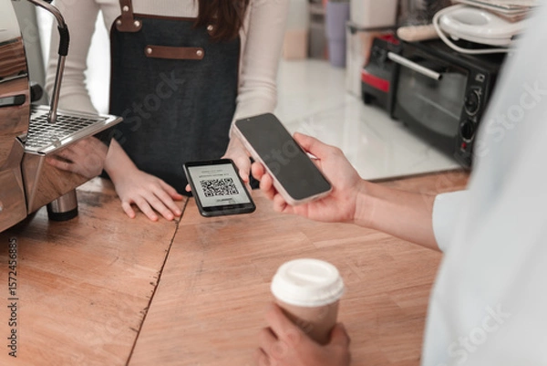 Obraz Customer completes mobile payment in urban setting, close-up on modern transaction technology