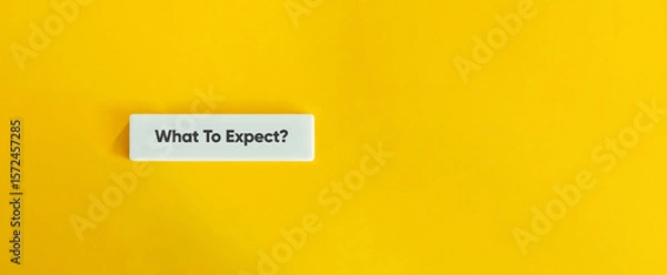 Fototapeta What To Expect Text on Minimal Wide Letter Tile with Yellow Background