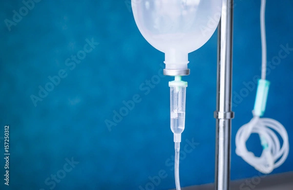 Obraz the Close up saline IV drip for patient and Infusion pump in hospital