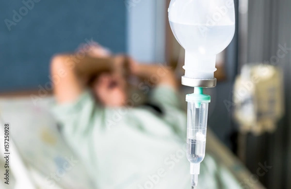 Obraz the saline IV drip over patient and Infusion pump in hospital