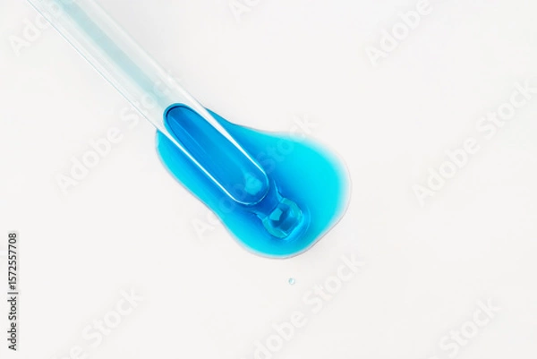 Fototapeta Drop of cosmetics and a pipette on a white background. A product for skin, face or hair care.