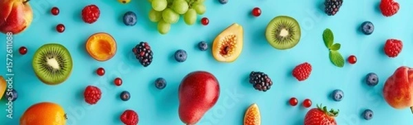 Obraz Vibrant assortment of colorful fruits arranged against a refreshing teal backdrop