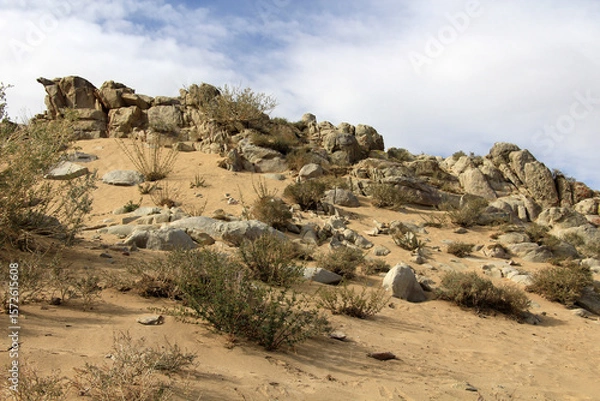 Fototapeta A rocky terrain in rural Mongolia that has begun to turn into desert. Due to climatic conditions, the rocks have turned into desert sand.
