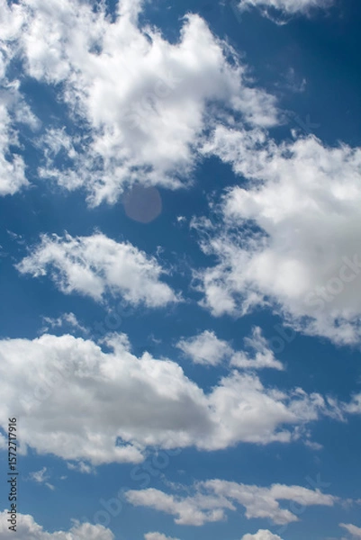 Fototapeta Vertical blue sky with clouds Background