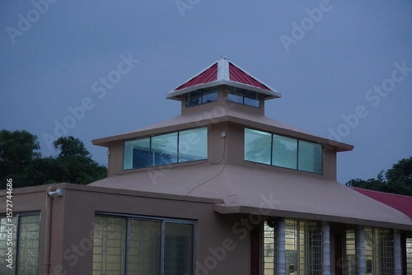 Fototapeta Building with a unique and multi-tiered roof structure with prominent windows