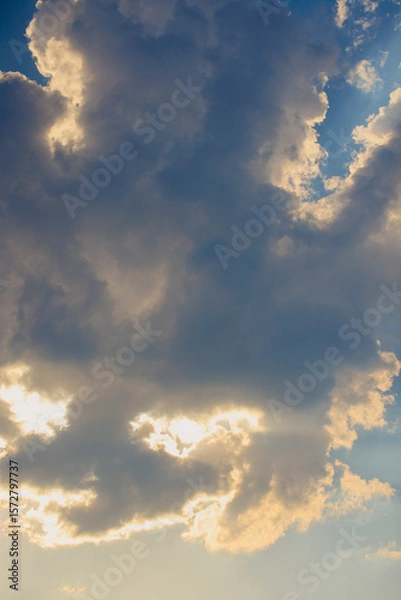Fototapeta Landscape with the sun hidden behind the clouds on a summer day