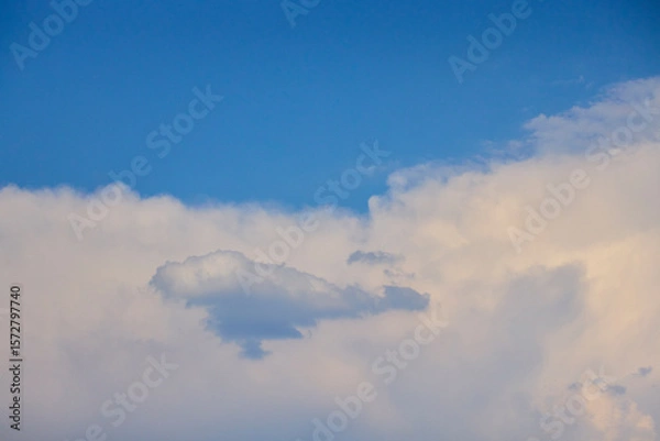 Fototapeta Landscape with the sun hidden behind the clouds on a summer day