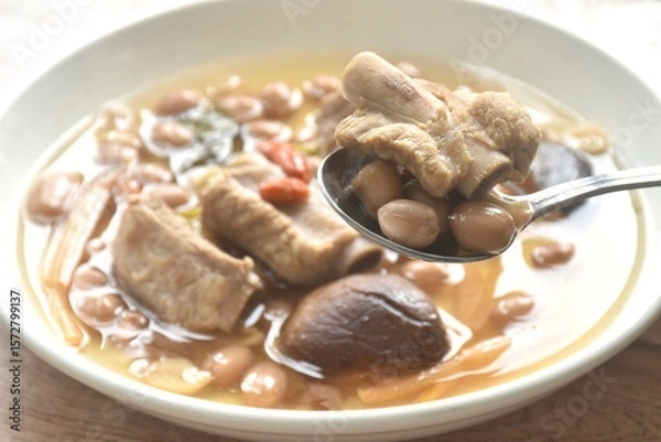 Obraz boiled chop pork bone with peanut and black mushroom soup on plate
