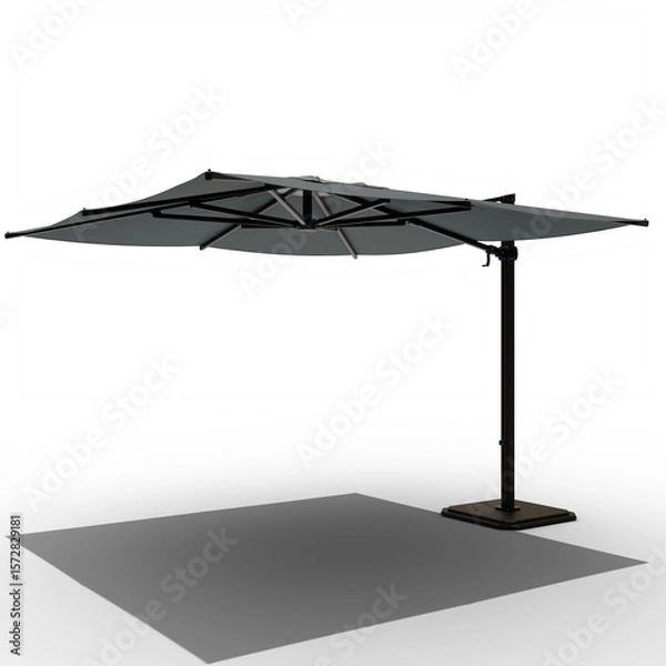 Fototapeta dark gray outdoor patio umbrella with a central pole and a rectangular, weighted base.  The canopy is segmented into panels, offering ample shade.  Its design suggests durability and modern aesthetics
