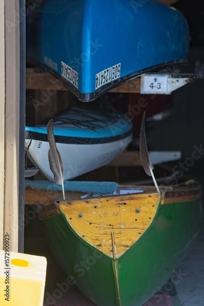 Fototapeta Colorful Boats in Garage with Feathers