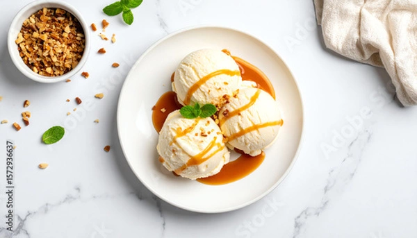 Fototapeta Delicious vanilla ice cream topped with caramel sauce and nuts, perfect for a refreshing dessert.
