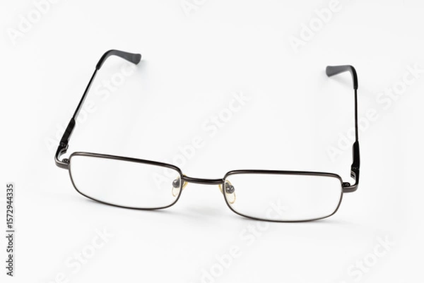 Fototapeta Rectangular reading glasses on white background. Concept of visual impairment