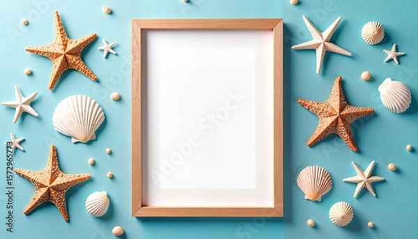 Fototapeta Wooden picture frame mock up surrounded by seashells and starfish on a textured blue background, beach decor concept. Free place for text