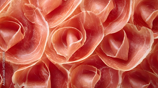 Fototapeta Thin prosciutto slices arranged like rose petals display their rich color and texture beautifully