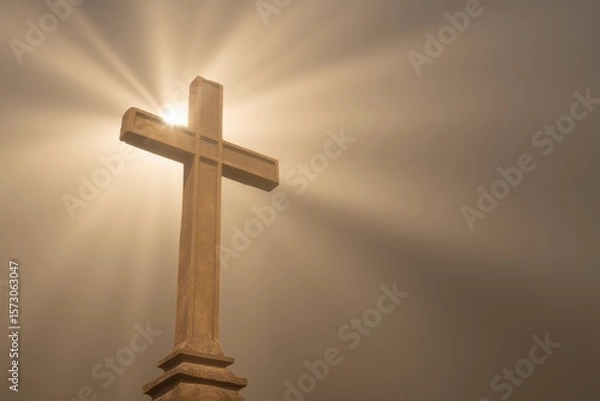 Obraz Ornate stone cross silhouetted against a foggy background creating a dramatic and cinematic atmosphere for religious themes and reflections