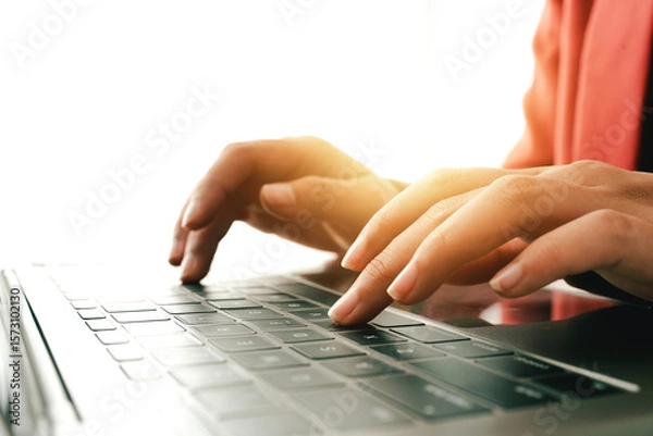 Fototapeta Close-up portrait typing keyboard on laptop computer. Working online on white table at office. Facebook chat. Website meeting. Blogger. Journalist writing articles. online job ideas