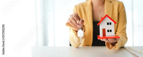 Fototapeta Real estate agent buys houses and land, delivers keys and house to customers after agreeing to sign a contract to buy a house and sign a loan contract, talks with real estate agents.