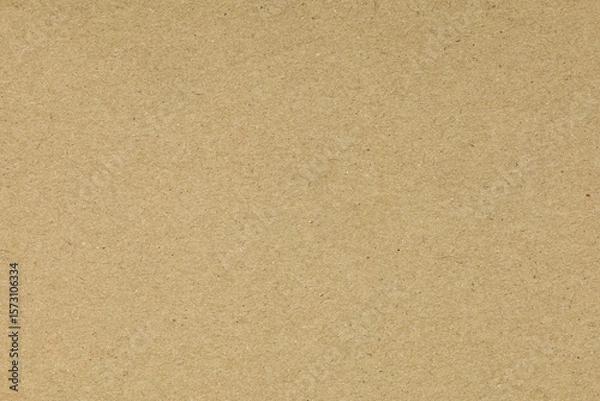 Fototapeta Brown craft paper texture background. High-resolution cardboard surface with fibrous detail for vintage design, packaging mockups, or as a natural, recycled wallpaper overlay.