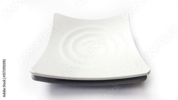 Fototapeta Stack of empty square white and grey plates with ceramic melamin material isolated on white background