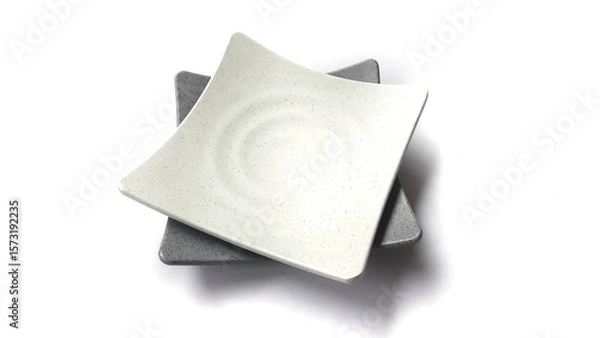 Fototapeta Stack of empty square white and grey plates with ceramic melamin material isolated on white background