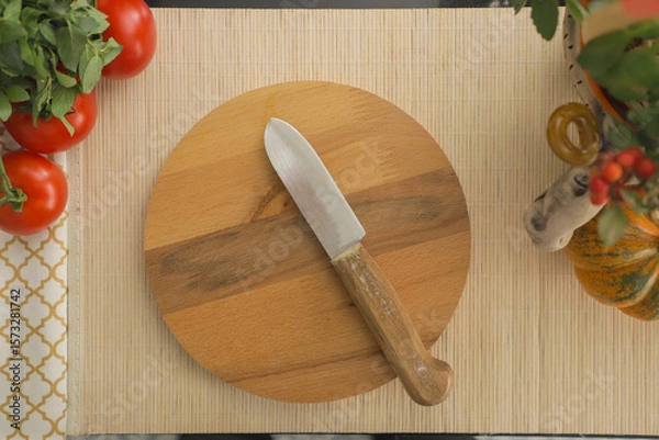 Fototapeta Rustic Wooden Cutting Board with Knife Surrounded by Fresh Tomatoes