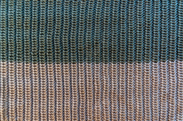 Fototapeta Knitted fabric with texture and two-tone pattern.The texture of a knitted sweater.