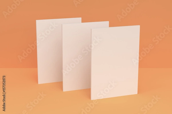 Obraz Three blank white closed brochure mock-up on orange background