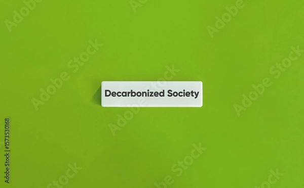 Fototapeta Decarbonized Society Message on Minimal Wide Letter Tile with Green Backdrop
