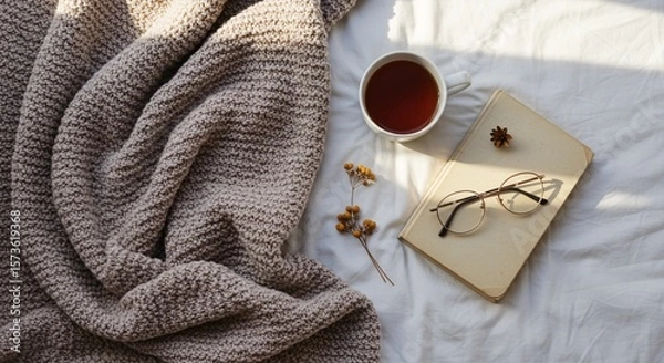 Obraz Flatlay of Tea and Book on Bed with Cozy Blanket