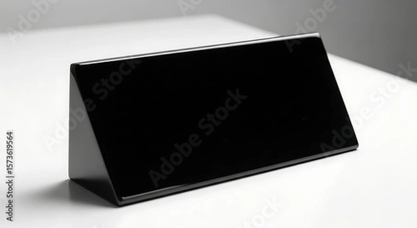 Fototapeta Sleek black nameplate against a minimalist white backdrop for corporate branding