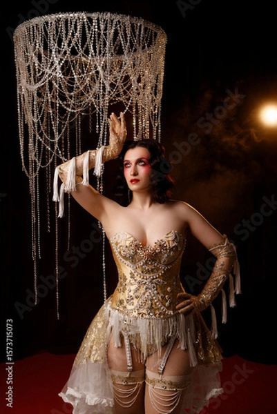 Fototapeta Caucasian female artist in golden Victorian-inspired corset costume, front view, dark background. Ideal for retro, Edwardian, cabaret, or theatrical performance themes.