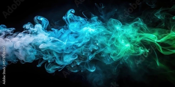 Fototapeta Mysterious aura of artificial smoke in blue green light on black background