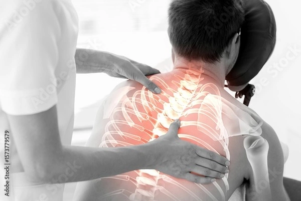 Obraz Rear view of injured man having back massage