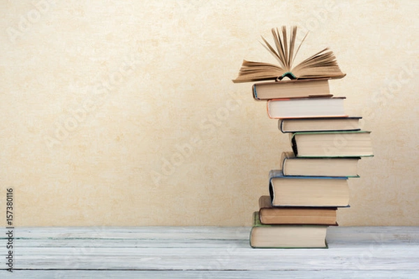 Fototapeta Stack of colorful books. Education background. Back to school. Book, hardback colorful books on wooden table. Education business concept. Copy space for text.