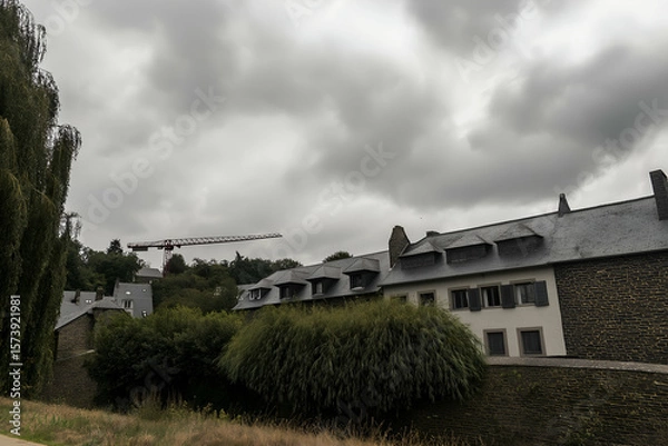 Obraz Viewing Stone Buildings with Trees and Crane Against Cloudy Sky. Mock up promotion information for marketing announcements and details, blank white space